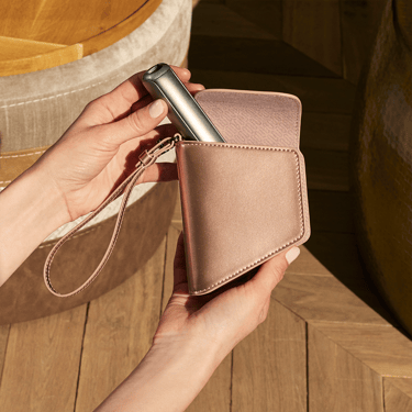 Hand holding a Ploom Duo Carry Case Rose Gold accessory