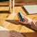 Hand showing a Ploom AURA device with a Navy Blue front panel accessory