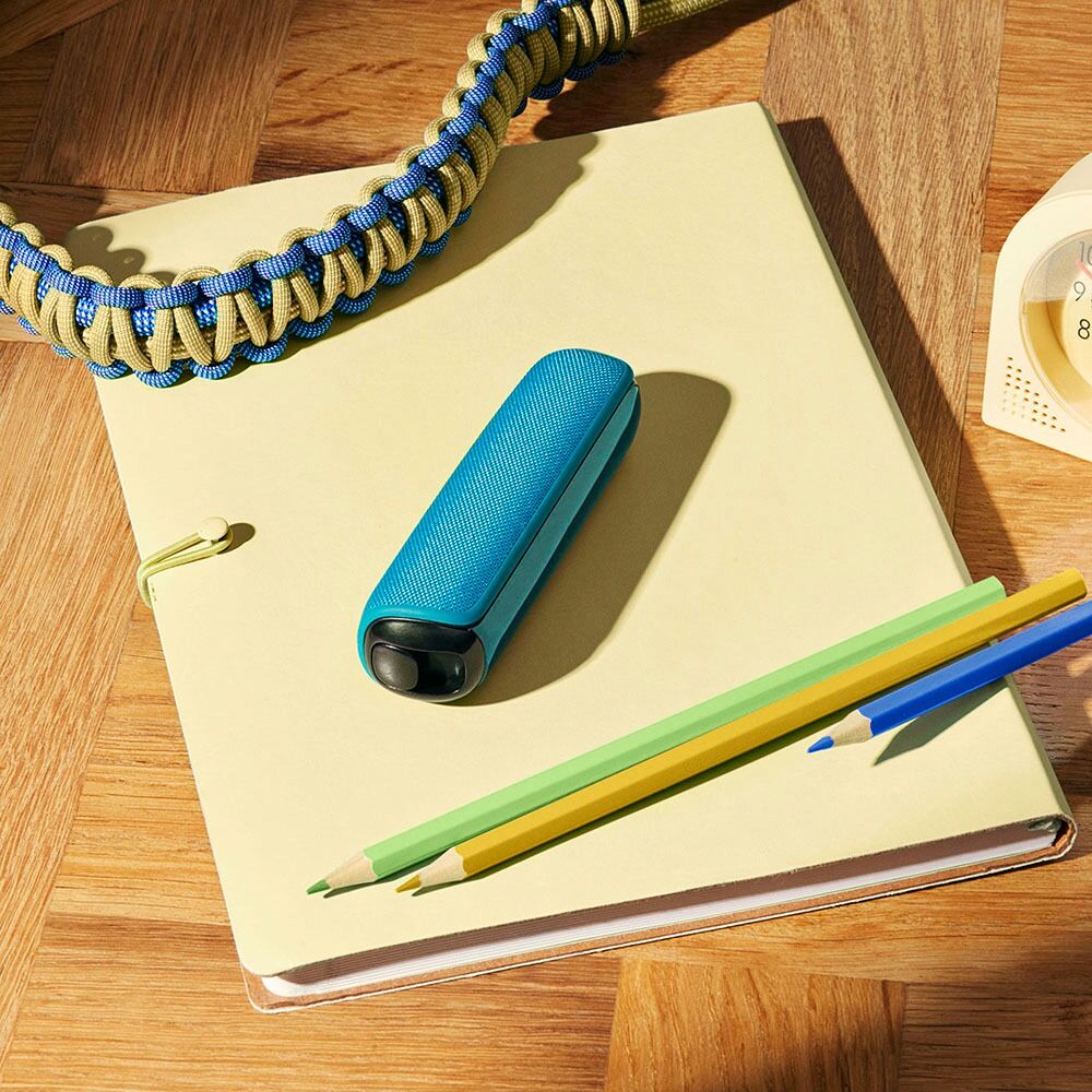 Ploom device with Ocean Blue Back Cover on notebook